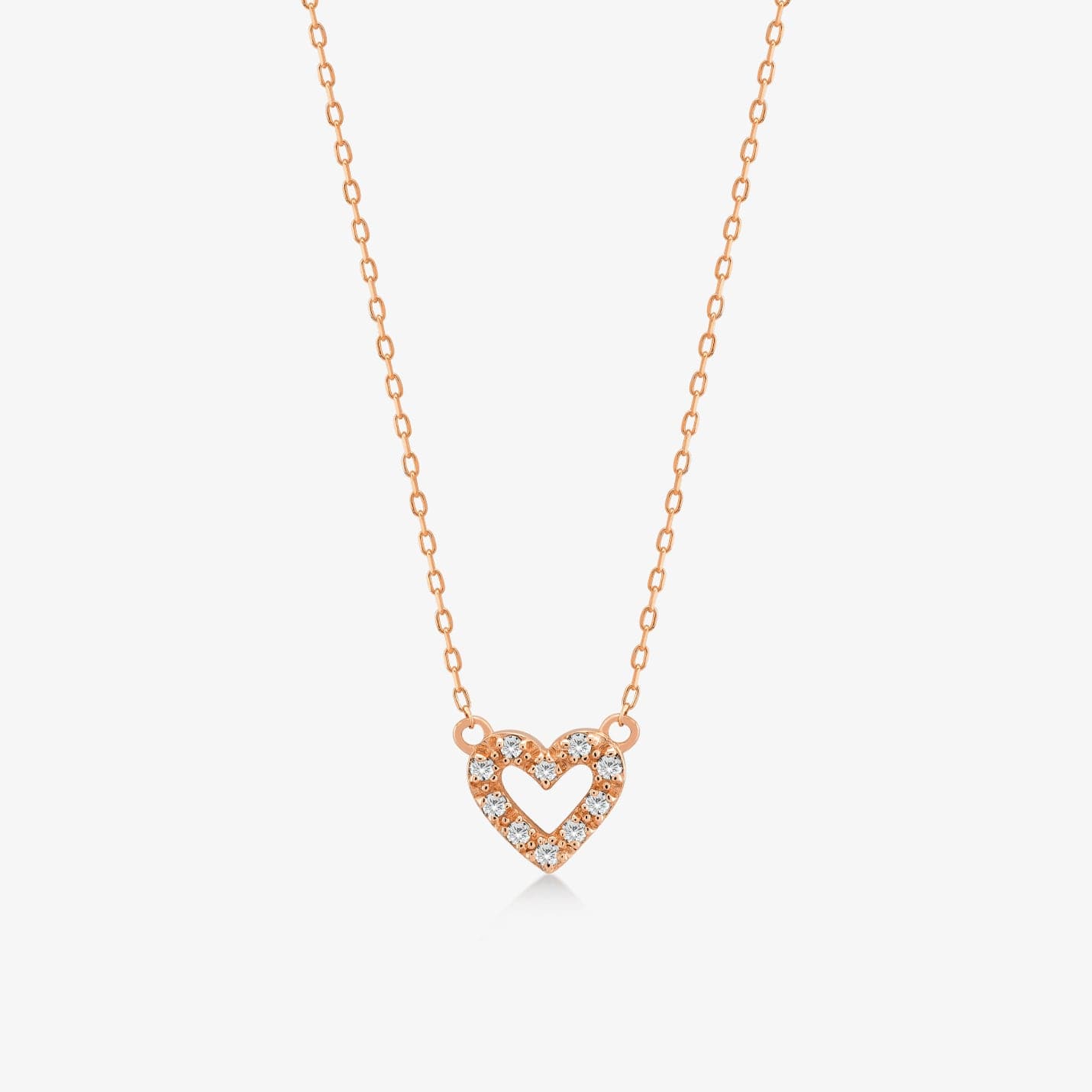 Collier pendentif en forme de coeur ouvert miniature avec diamants d'un poids total de 1/20 CT en or 14 carats.