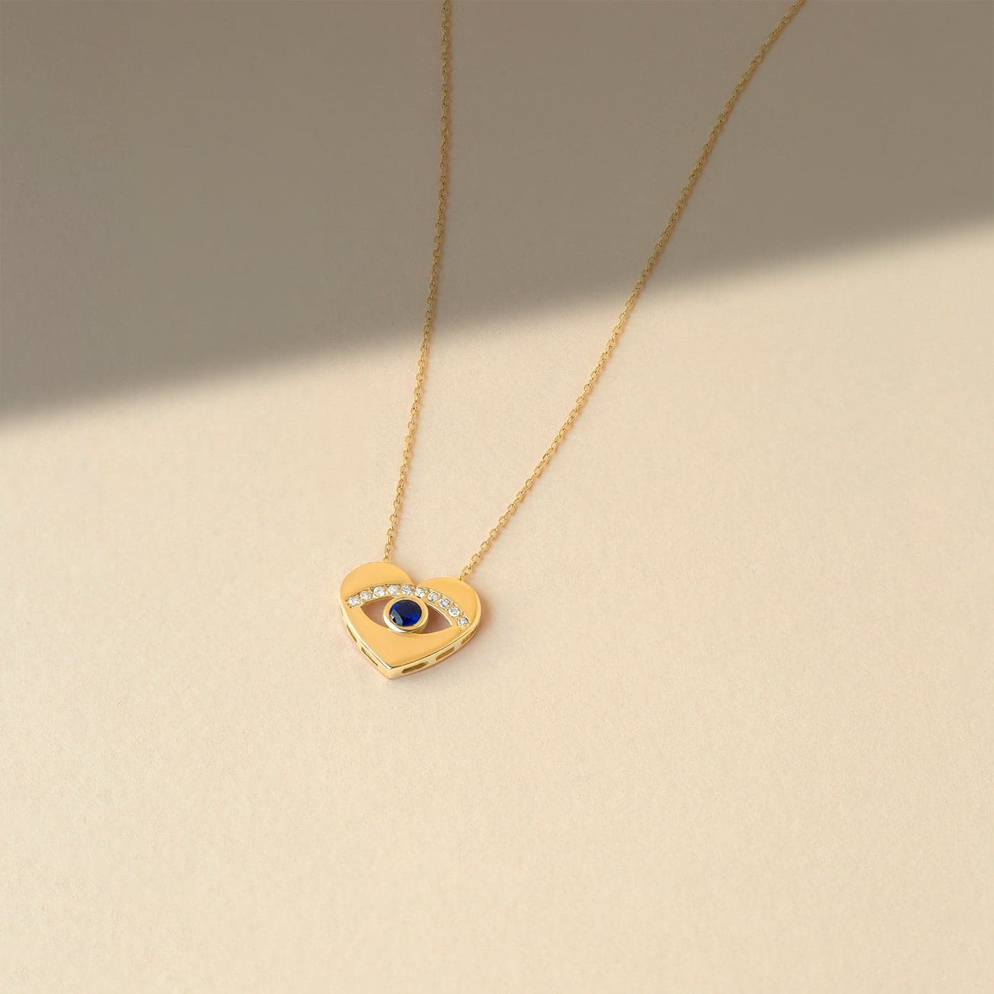 1/20 CT. T.W. Diamond & 1/8 CT. T.W. Sapphire Heart Evil Eye Pendant Necklace in 14K Solid Gold