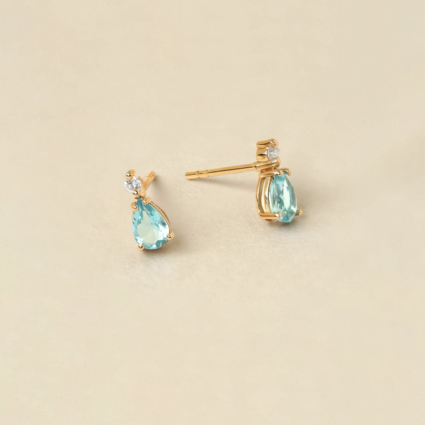 1/20 CT. T.W. Diamond and 1 CT. T.W. Pear-Shaped Blue Topaz Earrings in 14K Solid Gold