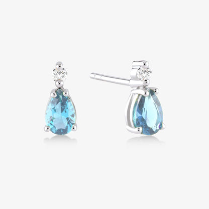 1/20 CT. T.W. Diamond and 1 CT. T.W. Pear-Shaped Blue Topaz Earrings in 14K Solid Gold